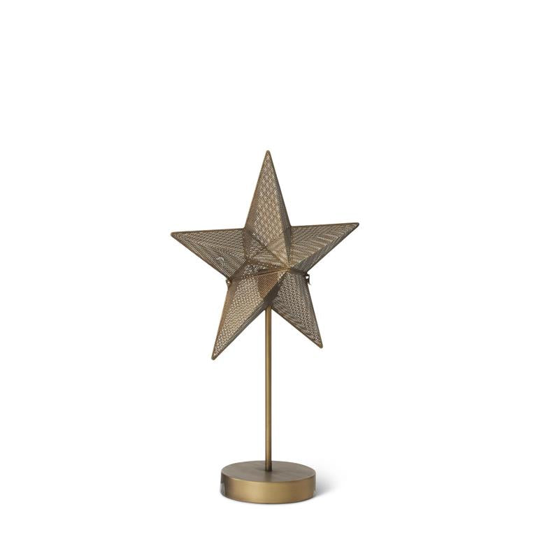 A decorative five-pointed star table lamp with a textured metallic bronze finish, mounted on a slim vertical stem with a round base, shown against a plain white background.