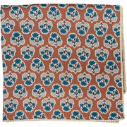 Cinnamon brown tablecloth with blue floral print and floral lace edge
