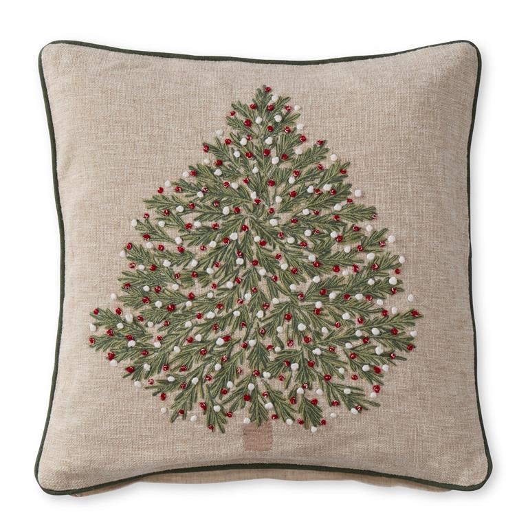 Decorative pillow with a Christmas tree design on a beige background