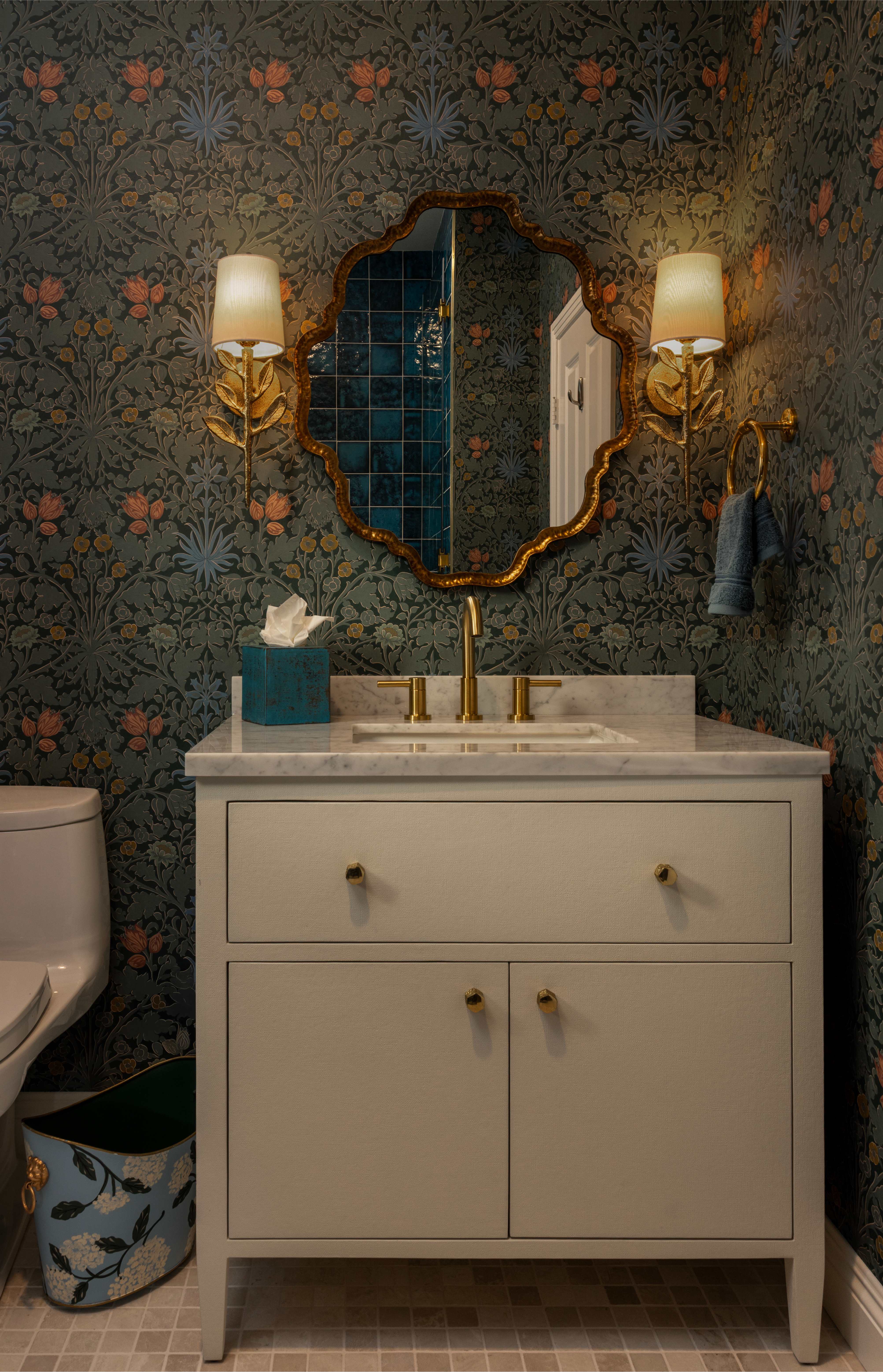 Bathroom vanity with floral wallpaper and decorative mirror