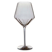 Smokey colored wine glass on a white background