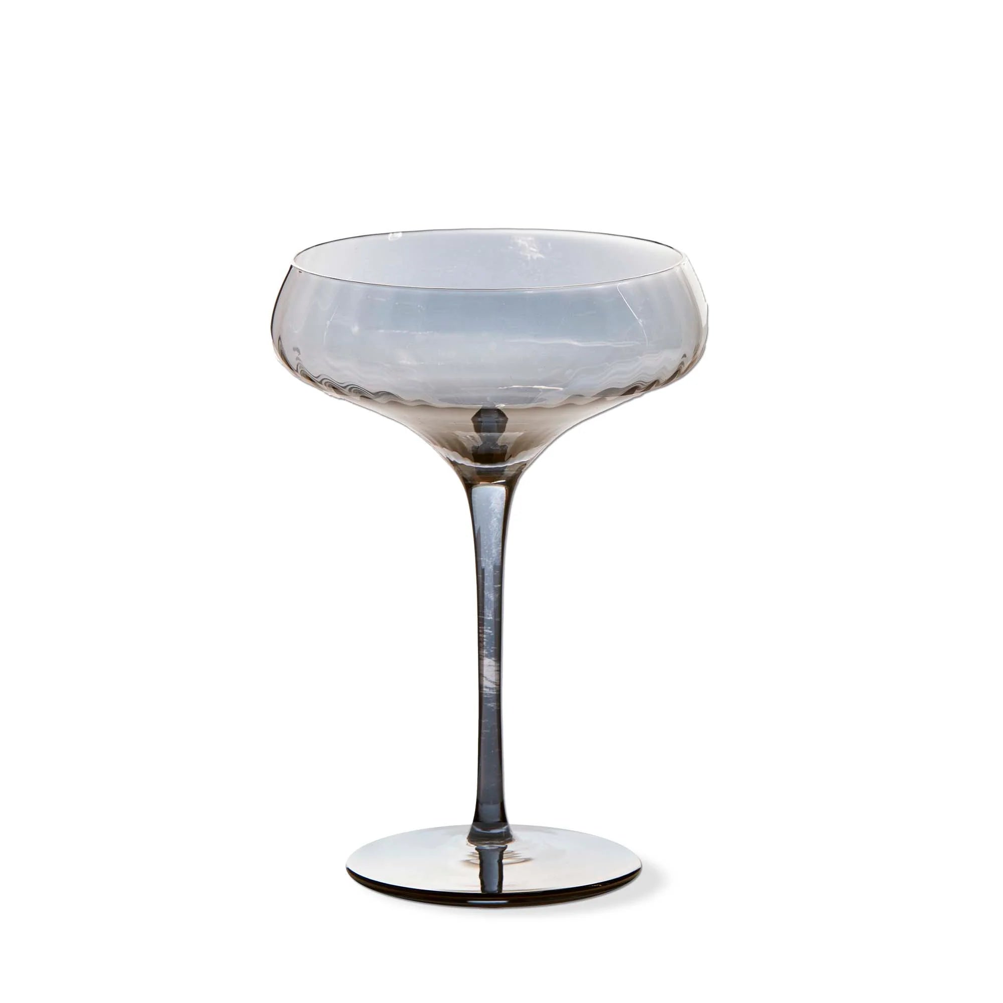 Decorative stemmed coupe glass with a white and gray smoke iridescent color  on a white background