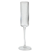 Clear ribbed champagne flute on a white background