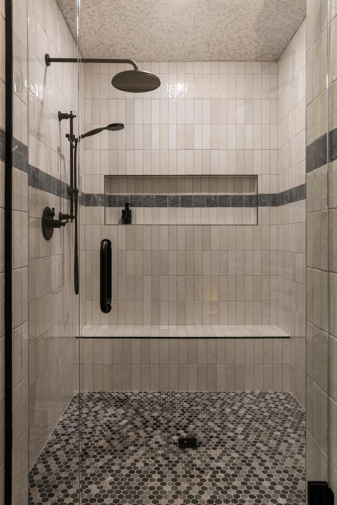 Modern shower with tiled walls and a glass door
