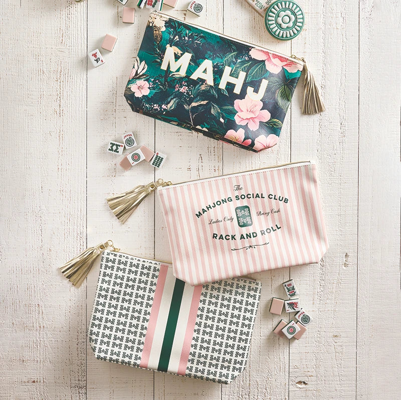 Mahjong game pieces and bags on a wooden surface